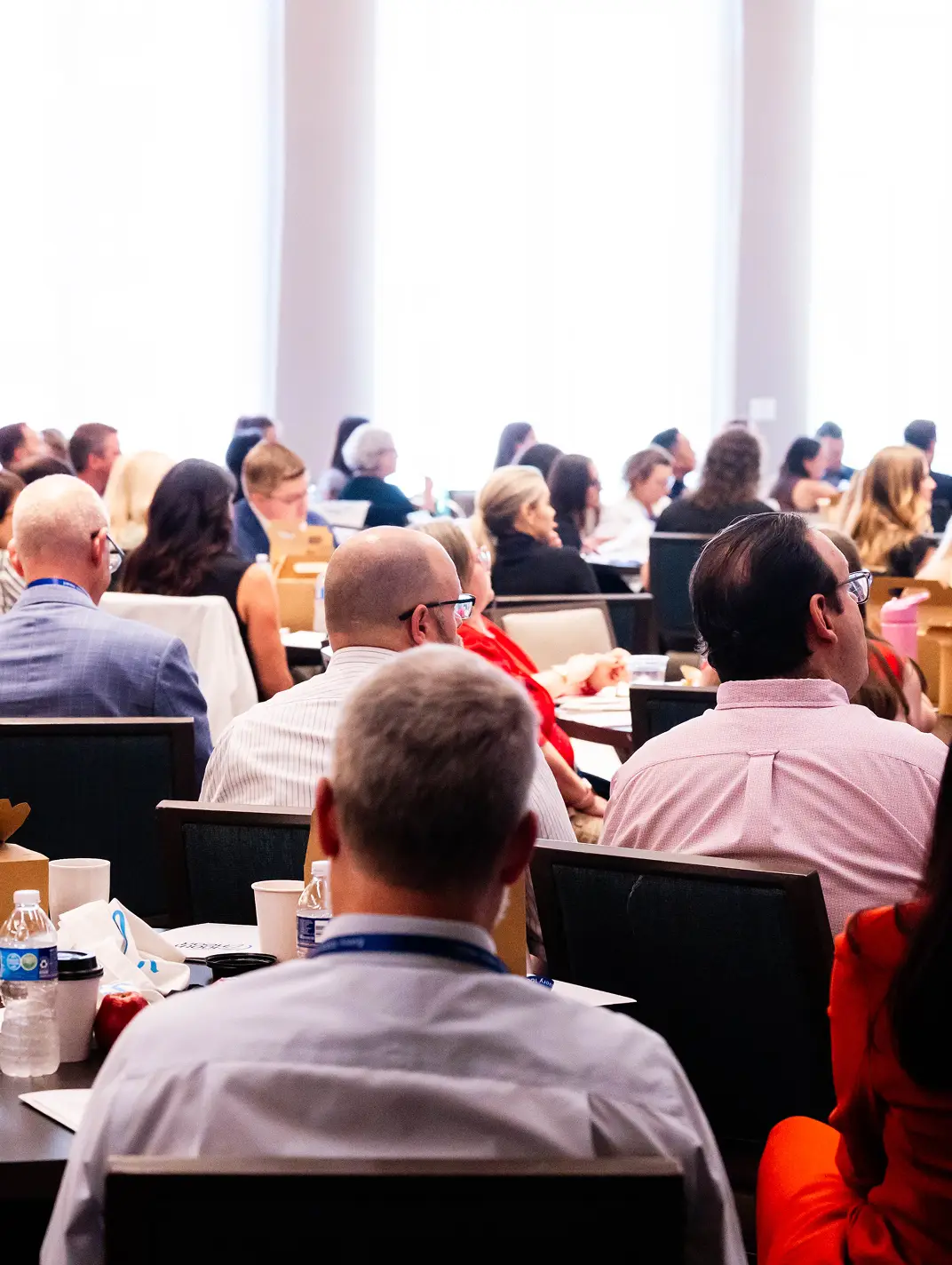 Summit attendees listening to a presentation